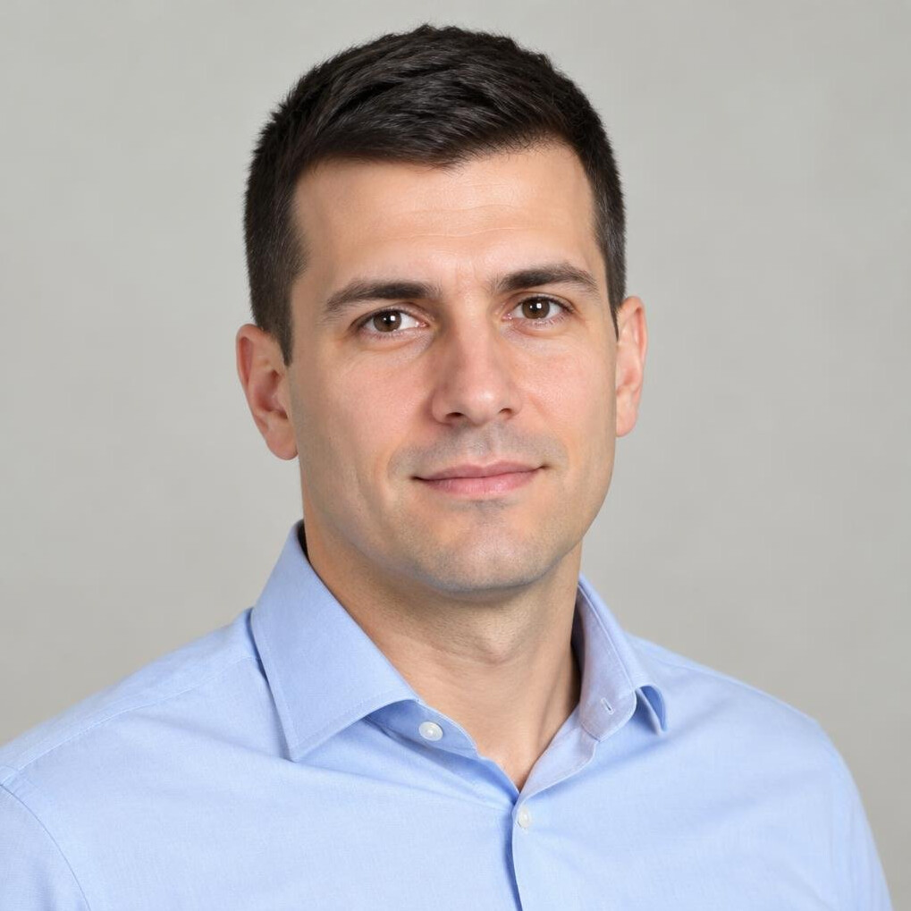 Portrait of a man in a light shirt looking at the camera